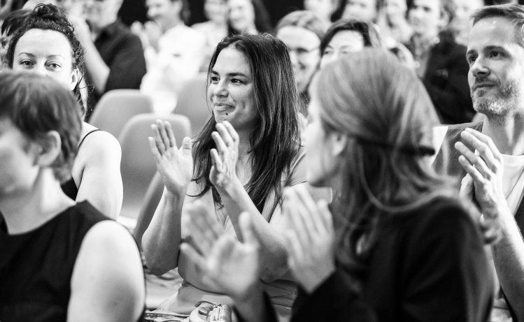 Audience members applauding at a film festival screening
