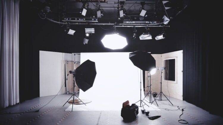 Film studio with softboxes, spotlights, and a white cyclorama backdrop