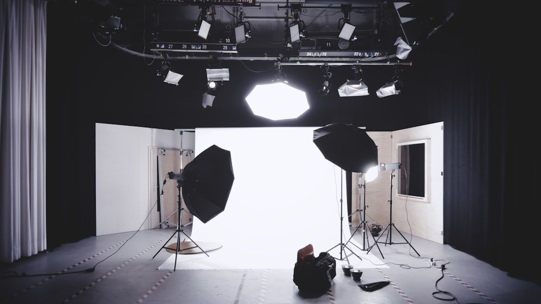 Film studio with softboxes, spotlights, and a white cyclorama backdrop