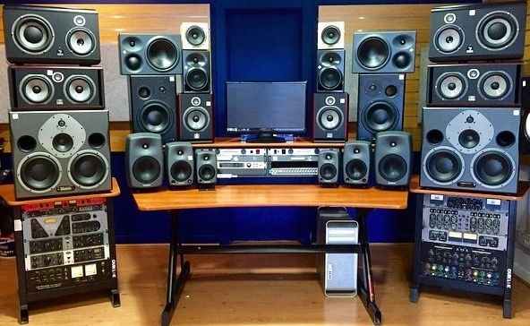 Audio editing setup with speakers, monitor, and rack-mounted equipment